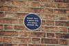 Plaque on the Community centre, marking the site of the Roman wall, 1991.